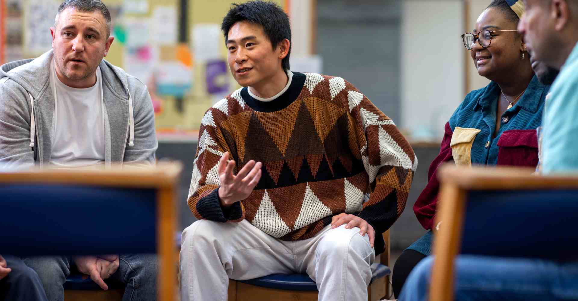 Diverse mental health support group meeting at a school.