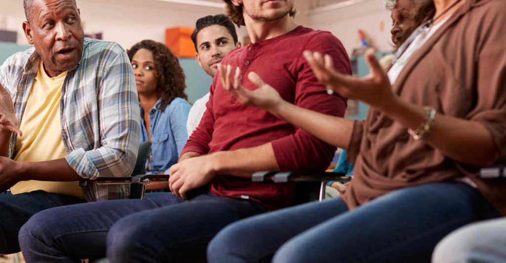 Diverse group of people having a discussion and learning together.