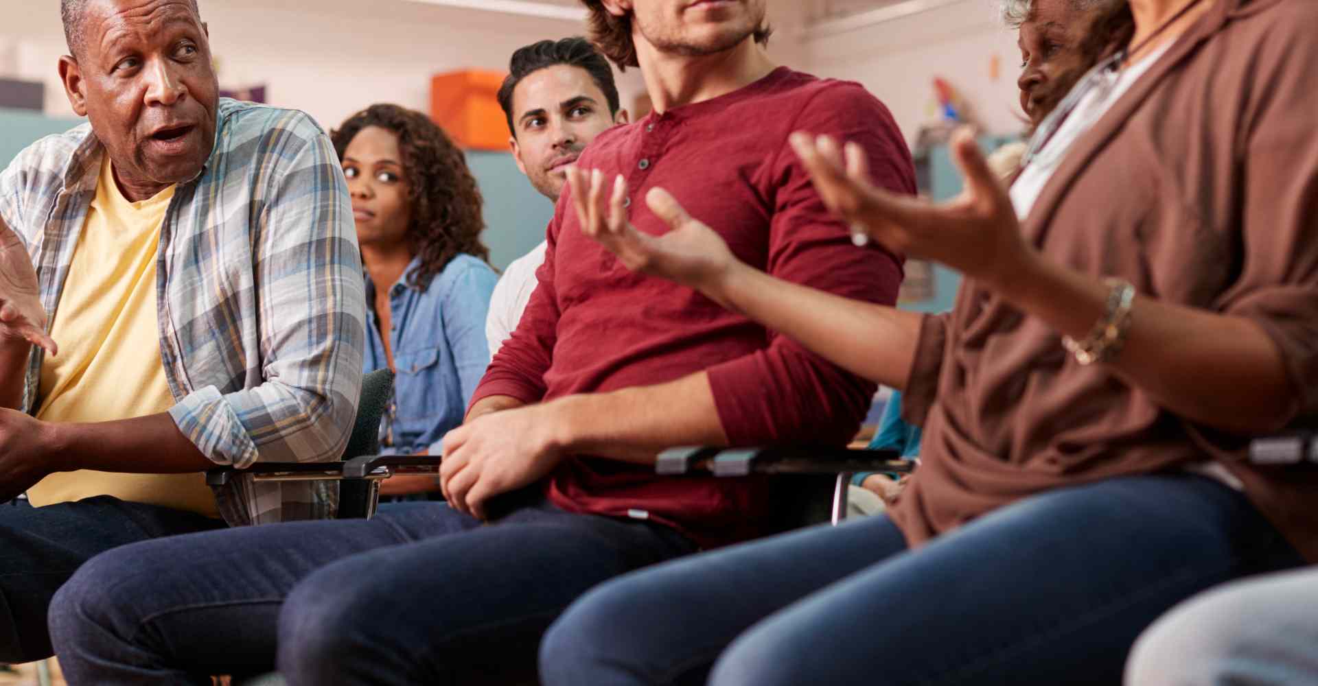 Diverse group of people having a discussion and learning together.