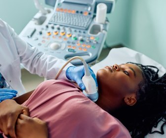 Young Black woman being examined by an endocrinologist after being exposed to an endocrine disrupting chemical in her childhood.