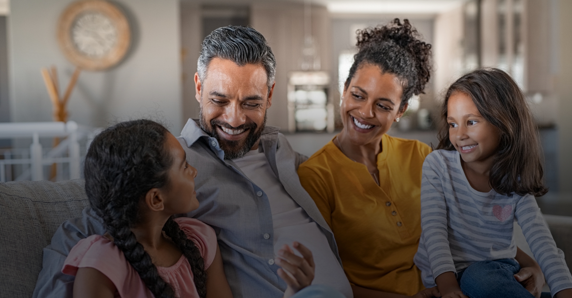 Hispanic family of four smiling together