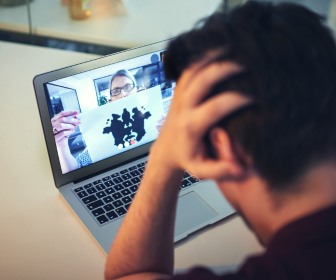 Man experiencing a mental health crisis on a telehealth treatment call with his behavioral health provider. 